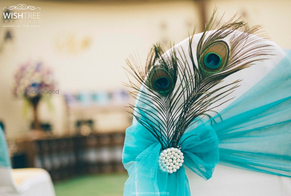 Photo of Unique chair decor with peacock feathers