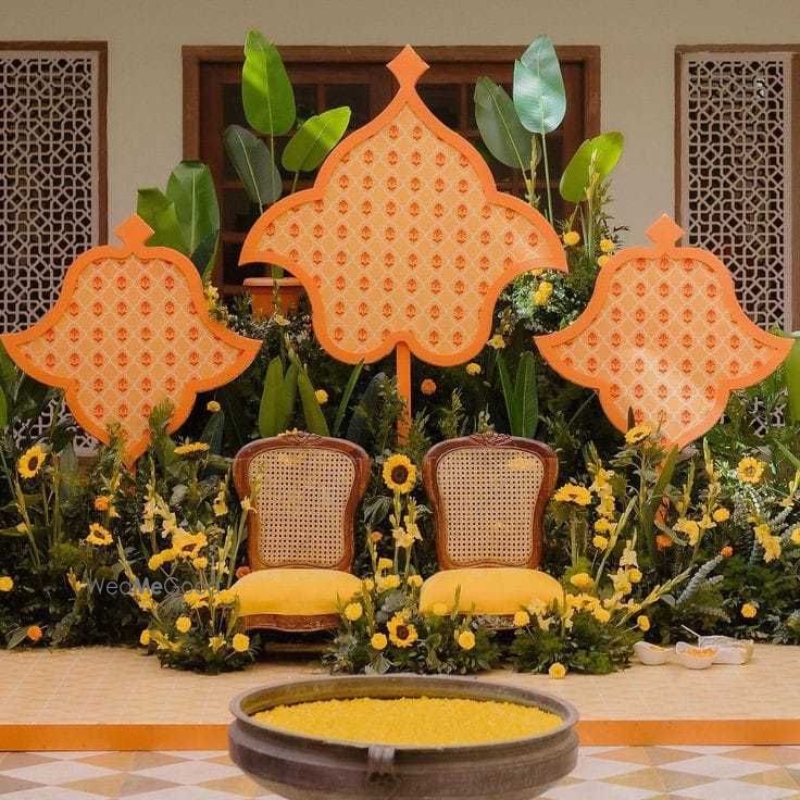 Photo of colorful yellow and orange haldi decor