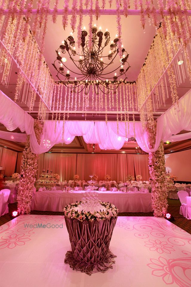 Photo of Light pink themed floral arrangement and chandelier