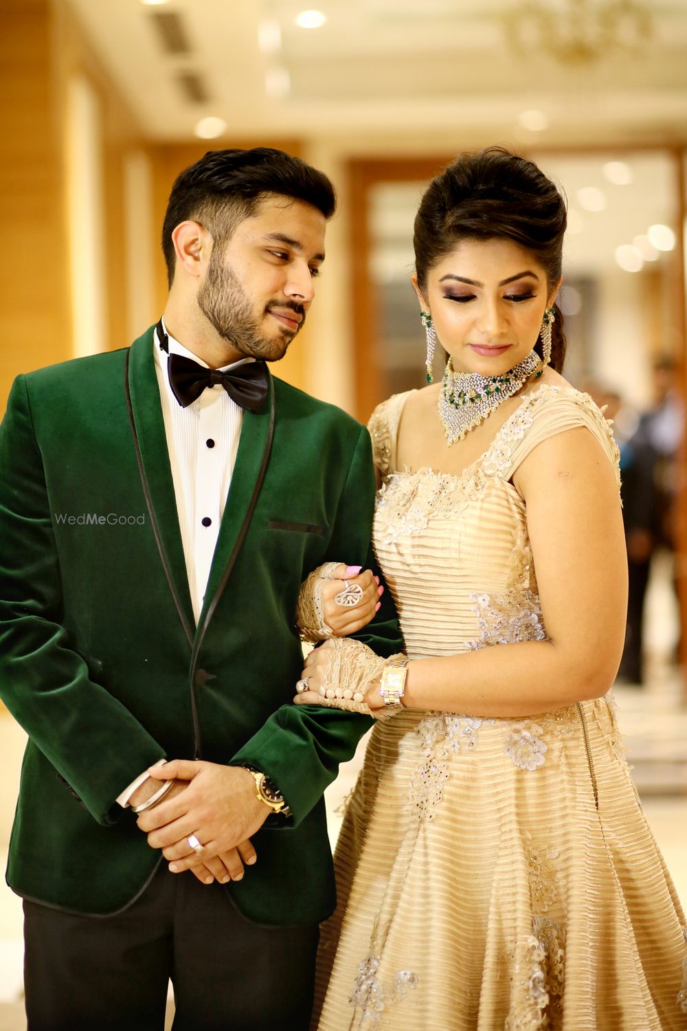 Photo of Groom in dark green western suit and bow tie