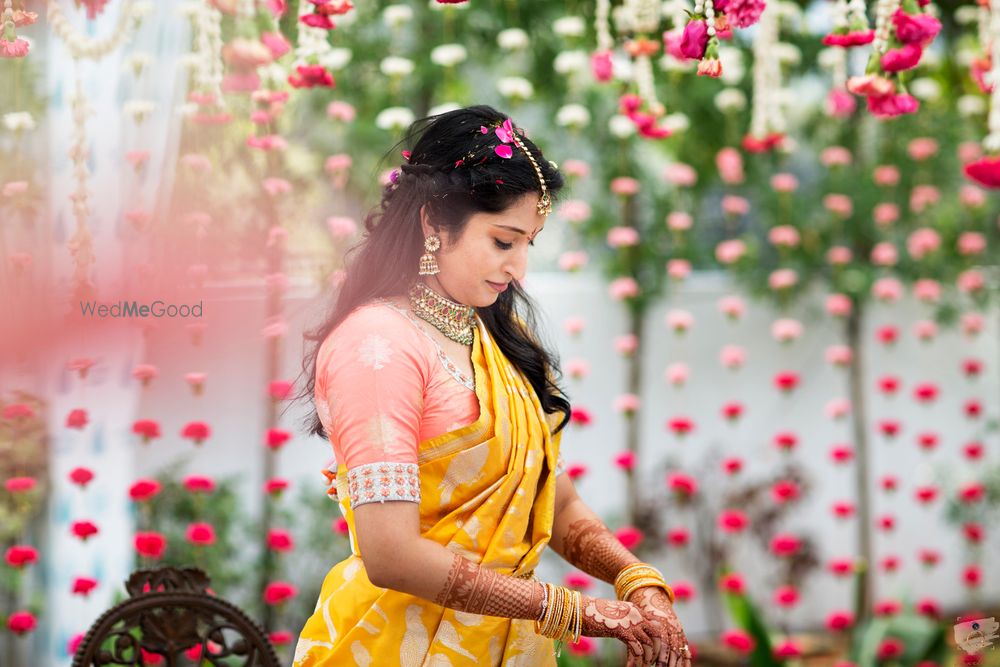 Photo of A bride in a yellow and peach silk saree