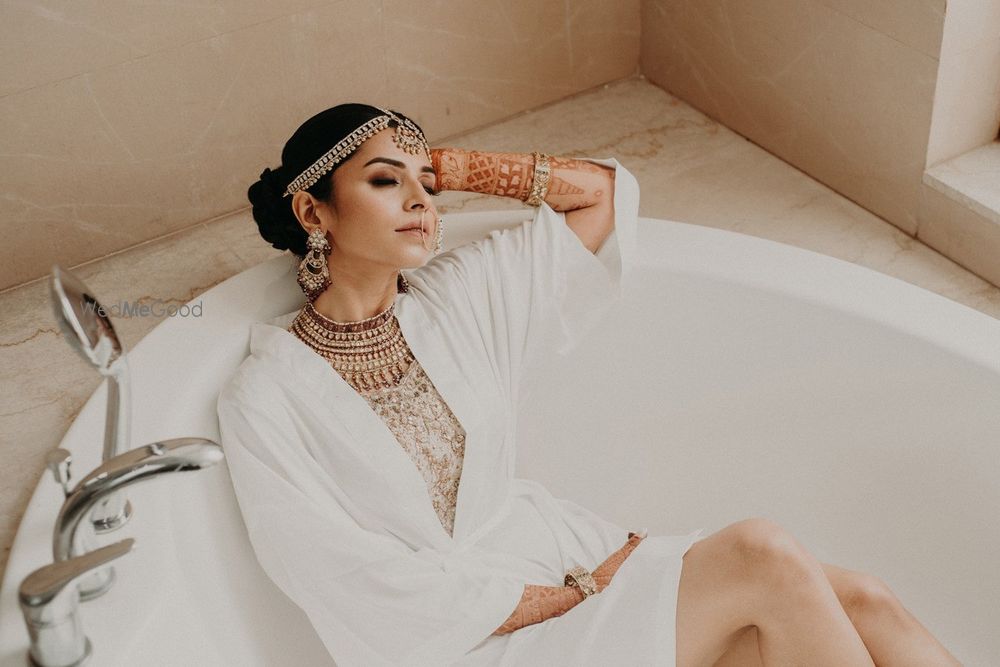 Photo of bridal getting ready shot idea in robe sitting in bathtub