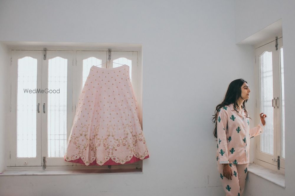 Photo of bride in night suit with lehenga on hanger