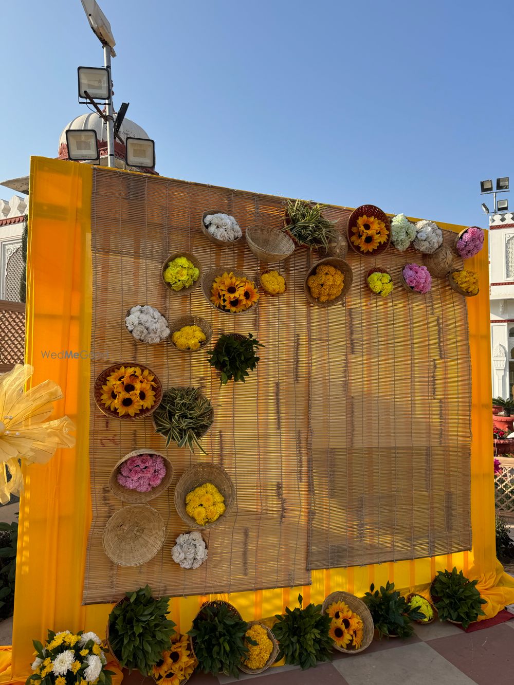 Photo of Rustic photobooth decor with burlap, cane baskets and florals.