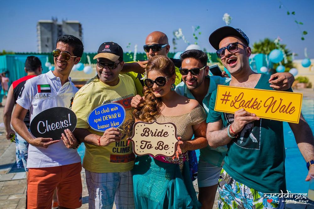 Photo of Bride with her squad and prop boards