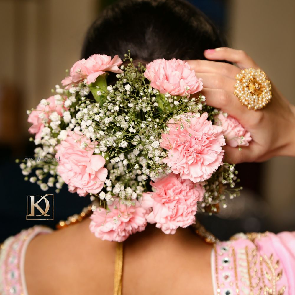 Photo of Floral bun hairstyle.