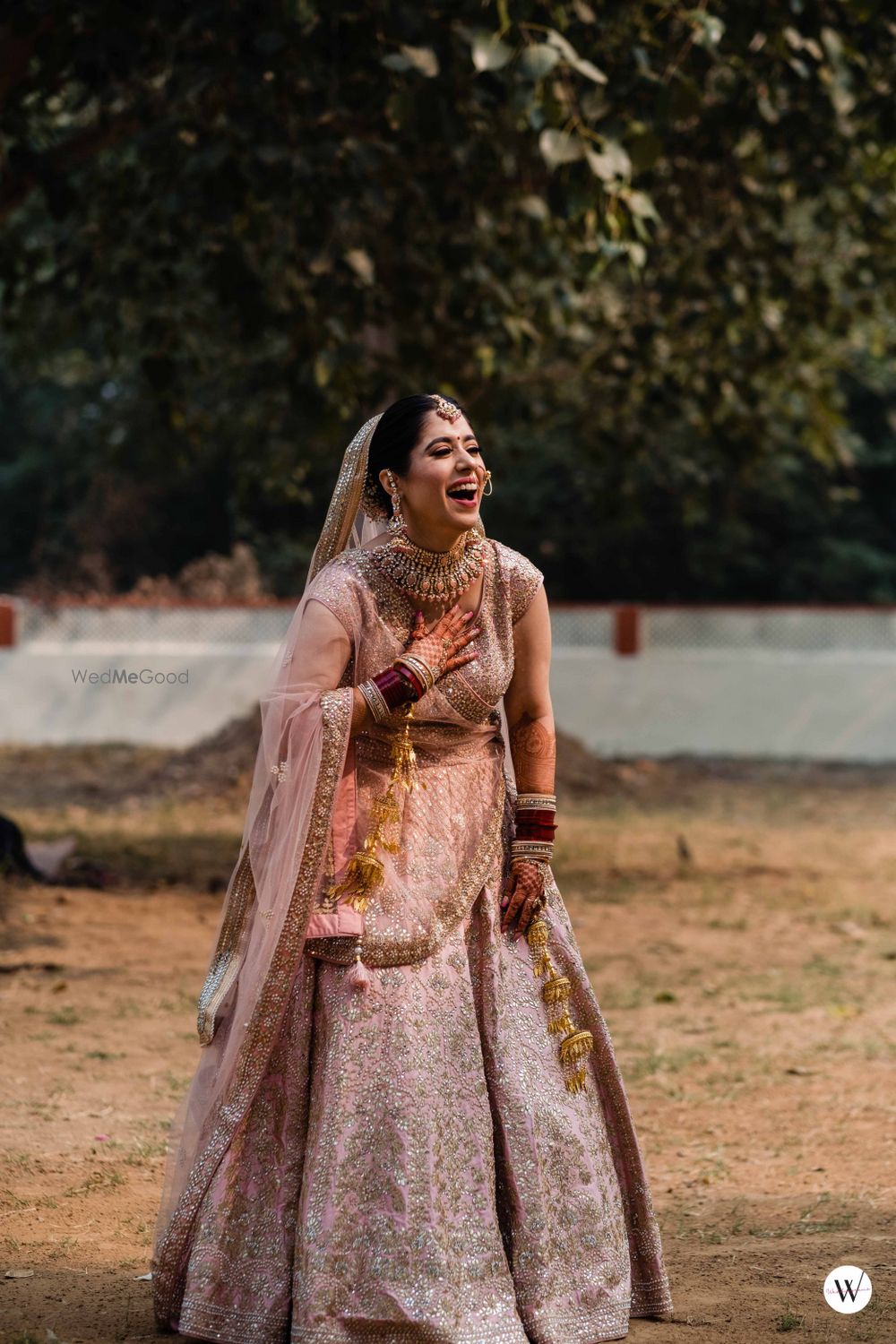 Photo of Candid bridal shot on wedding day with a bride in a pastel lehenga