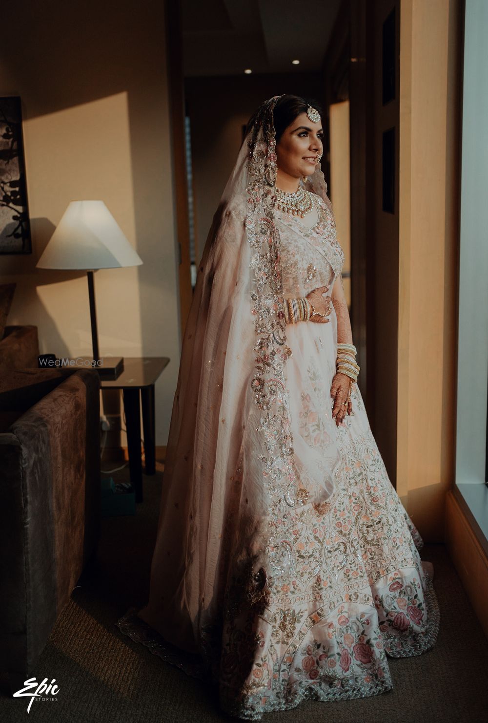 Photo of Bride wearing a pastel pink lehenga on her wedding day.