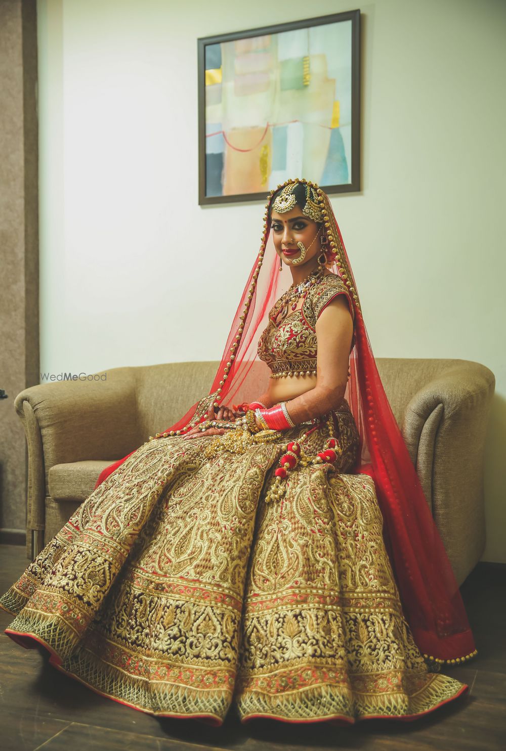 Photo of Gold embroidered lehenga with contrasting red dupatta