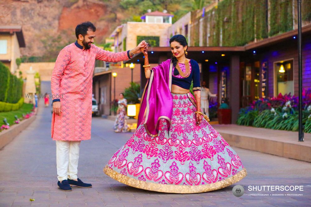 Photo of Bride in bright pink and blue threadwork lehenga for mehendi