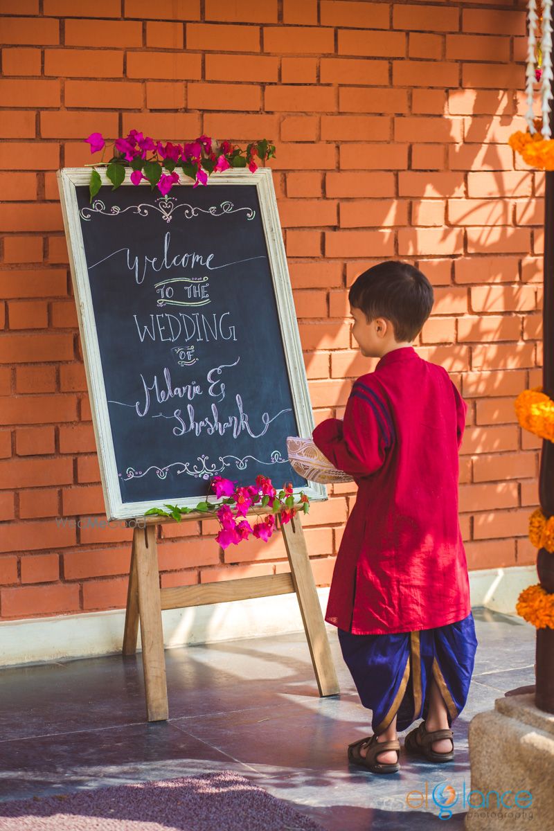 Photo of South Indian wedding entrance decor with personalised blackboard quote