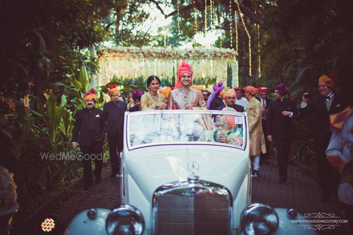 Photo of Groom entering in a white vintage car