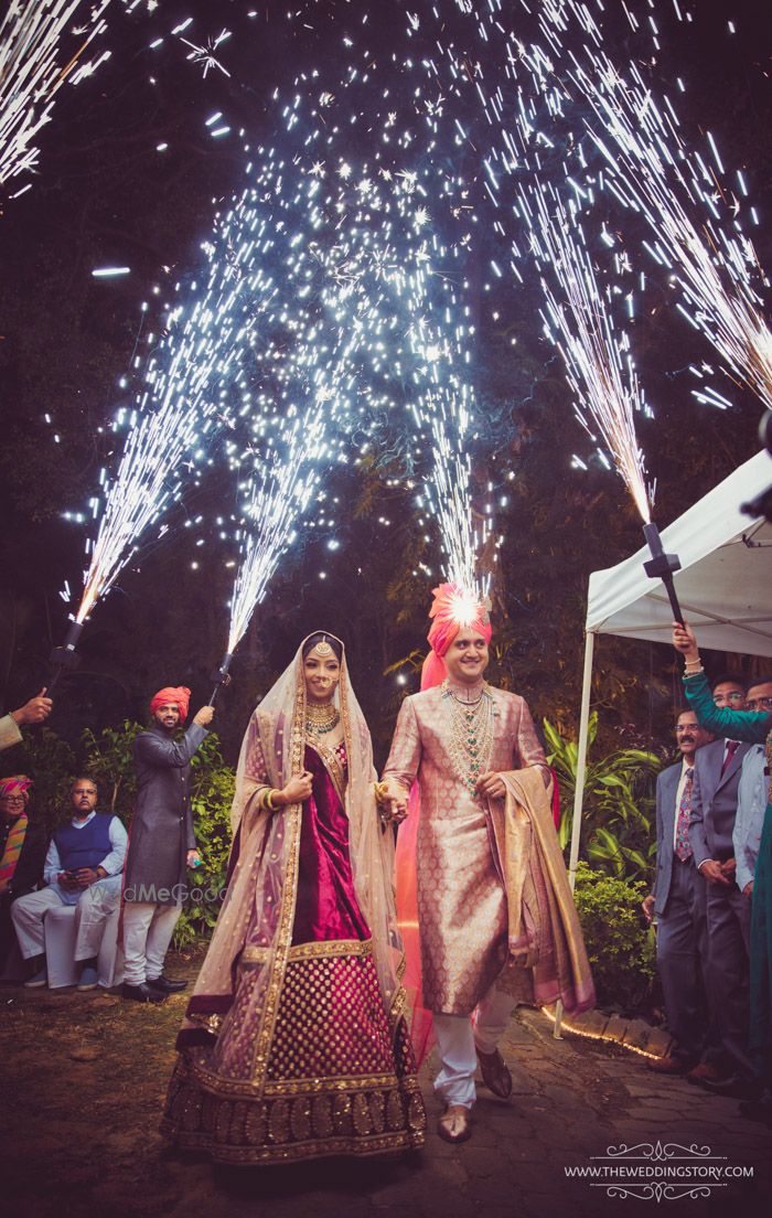 Photo of Guests holding cold pyros while couple enters