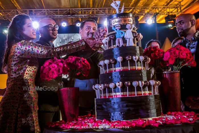 Photo of Quirky black wedding cake with lollipops