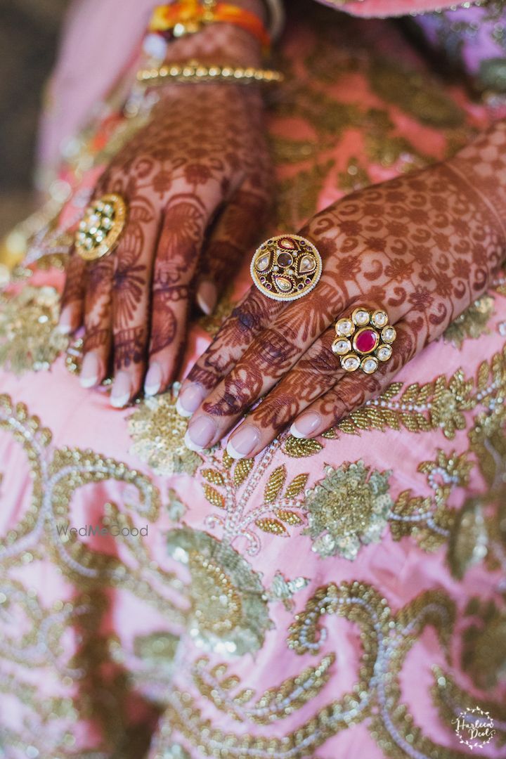 Photo of Bridal hands with rings and mehendi