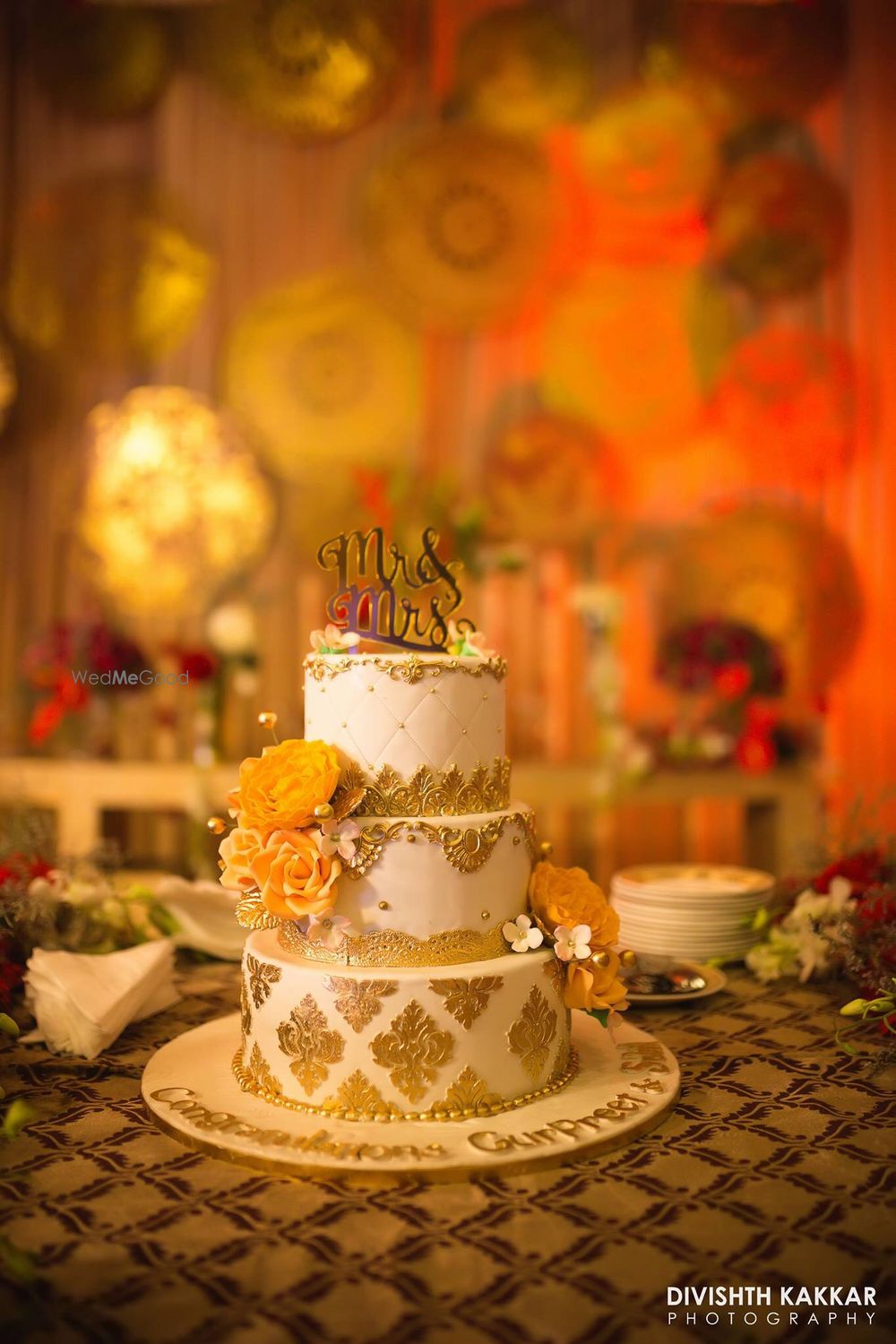 Photo of God and white wedding cake with Mr and mrs cake topper