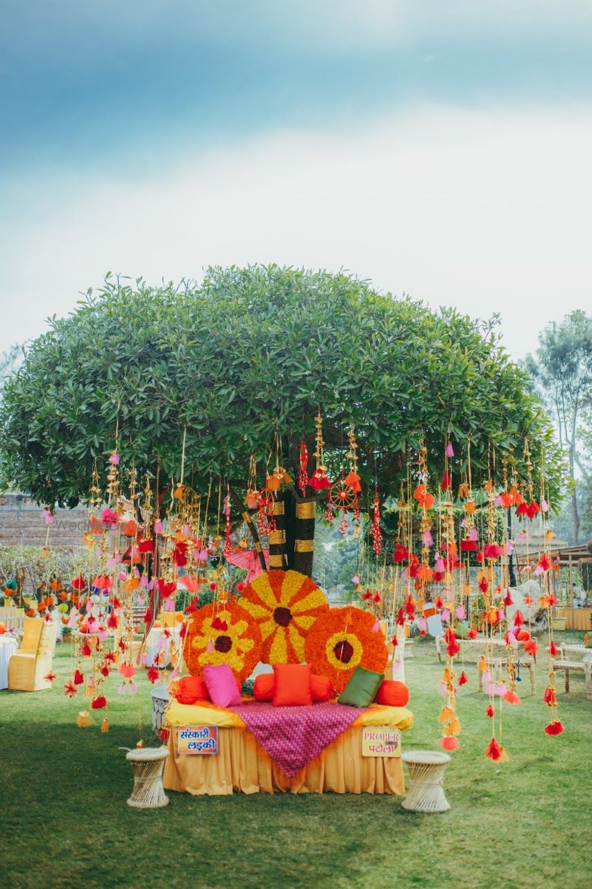 Photo of Beautiful mehendi seating for bride with colorful hanging elements