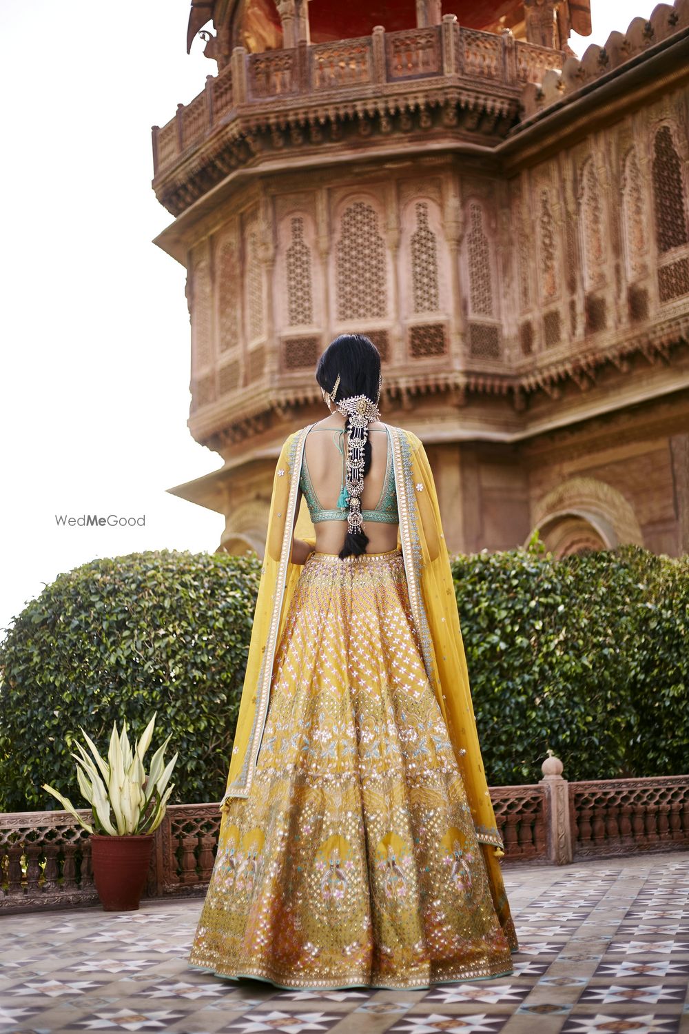 Photo of Back shot Anita dongre yellow and turquoise lehenga