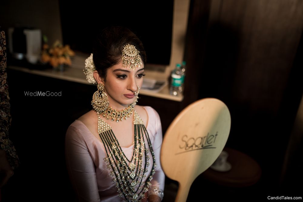 Photo of Bride getting ready shot looking into mirror