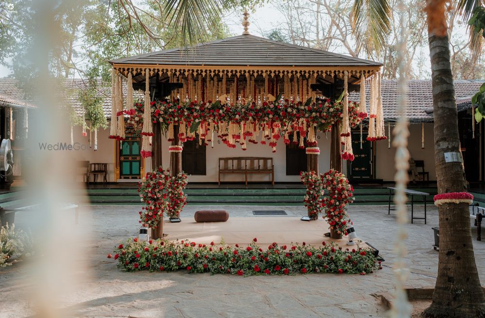 Photo of Beautiful south indian mandap decor with white and red florals for an outdoor wedding