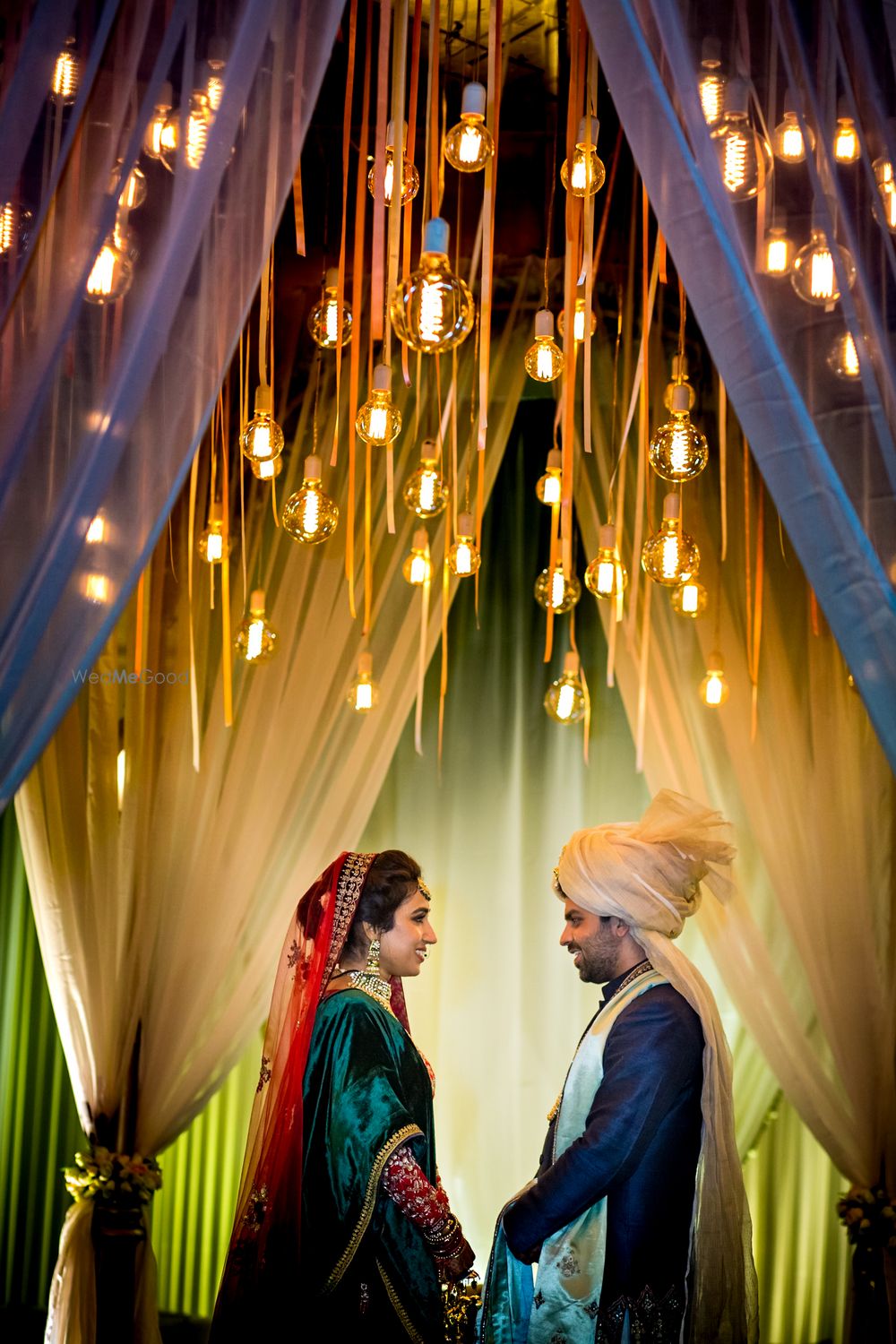 Photo of Couple holding hands shot with lights overhead