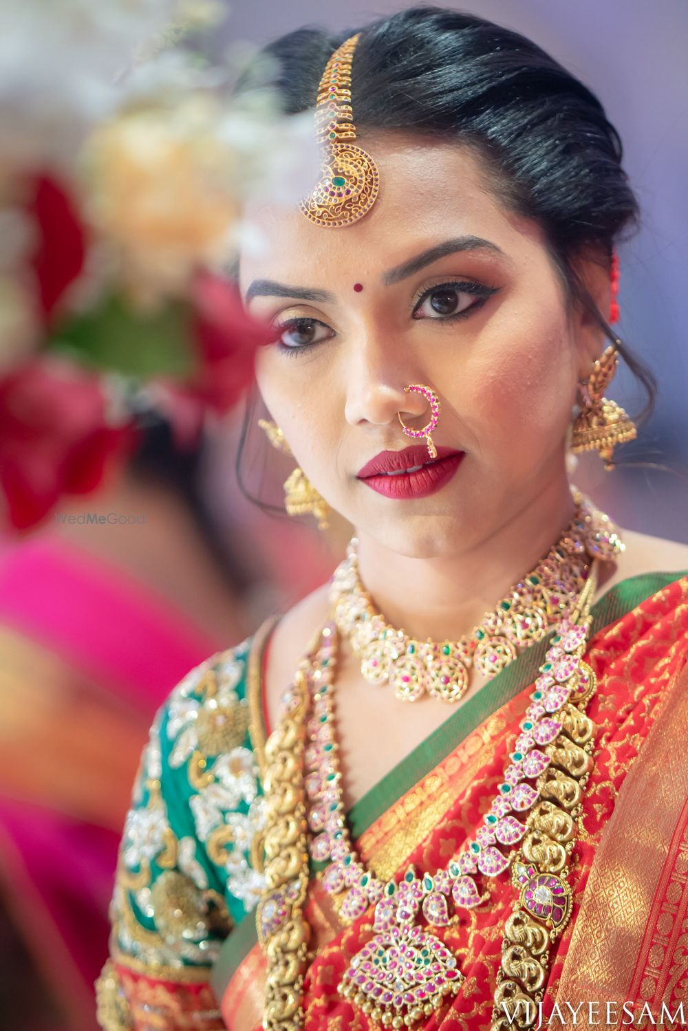 Photo of Layered south indian bridal jewellery with orange and green saree