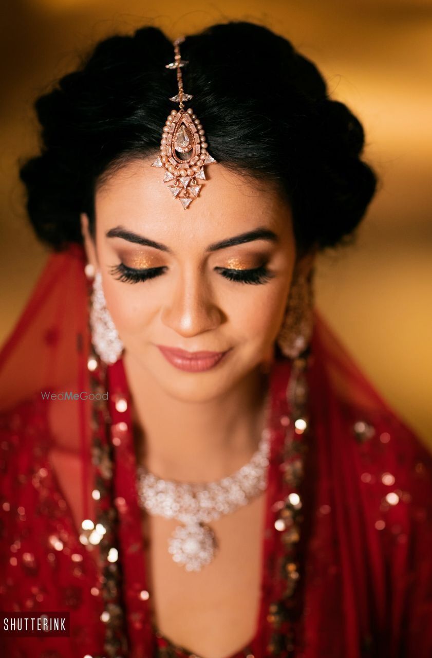 Photo of Simple and subtle bridal makeup with gold lids