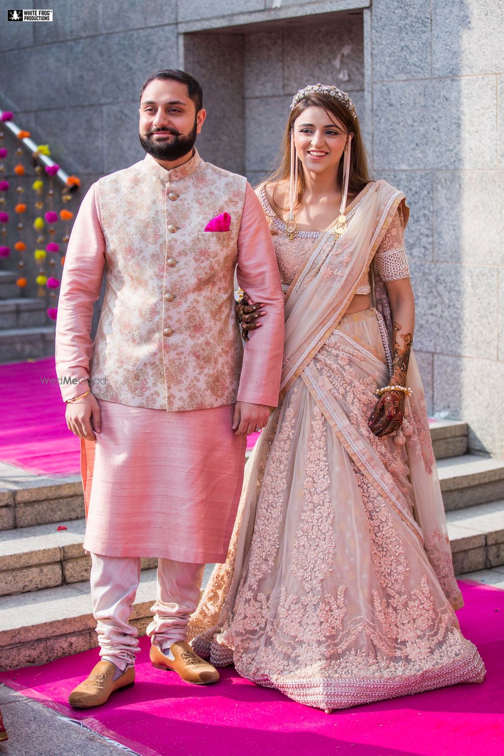 Photo of Matching bride and groom on mehendi in pastels