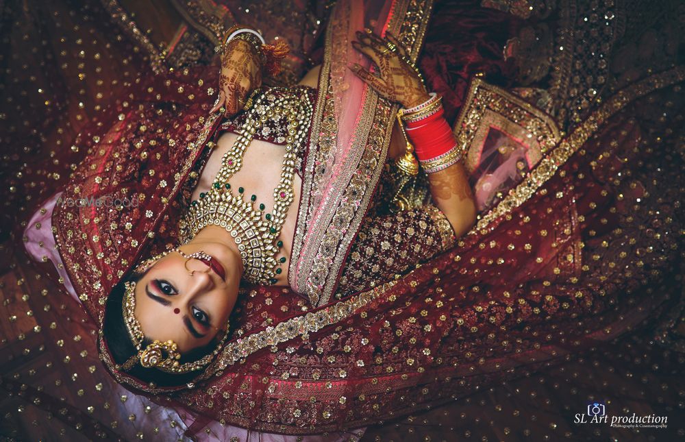 Photo of Unique bridal portrait with bride lying