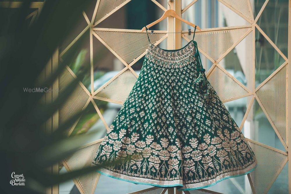 Photo of Dark green lehenga on hanger