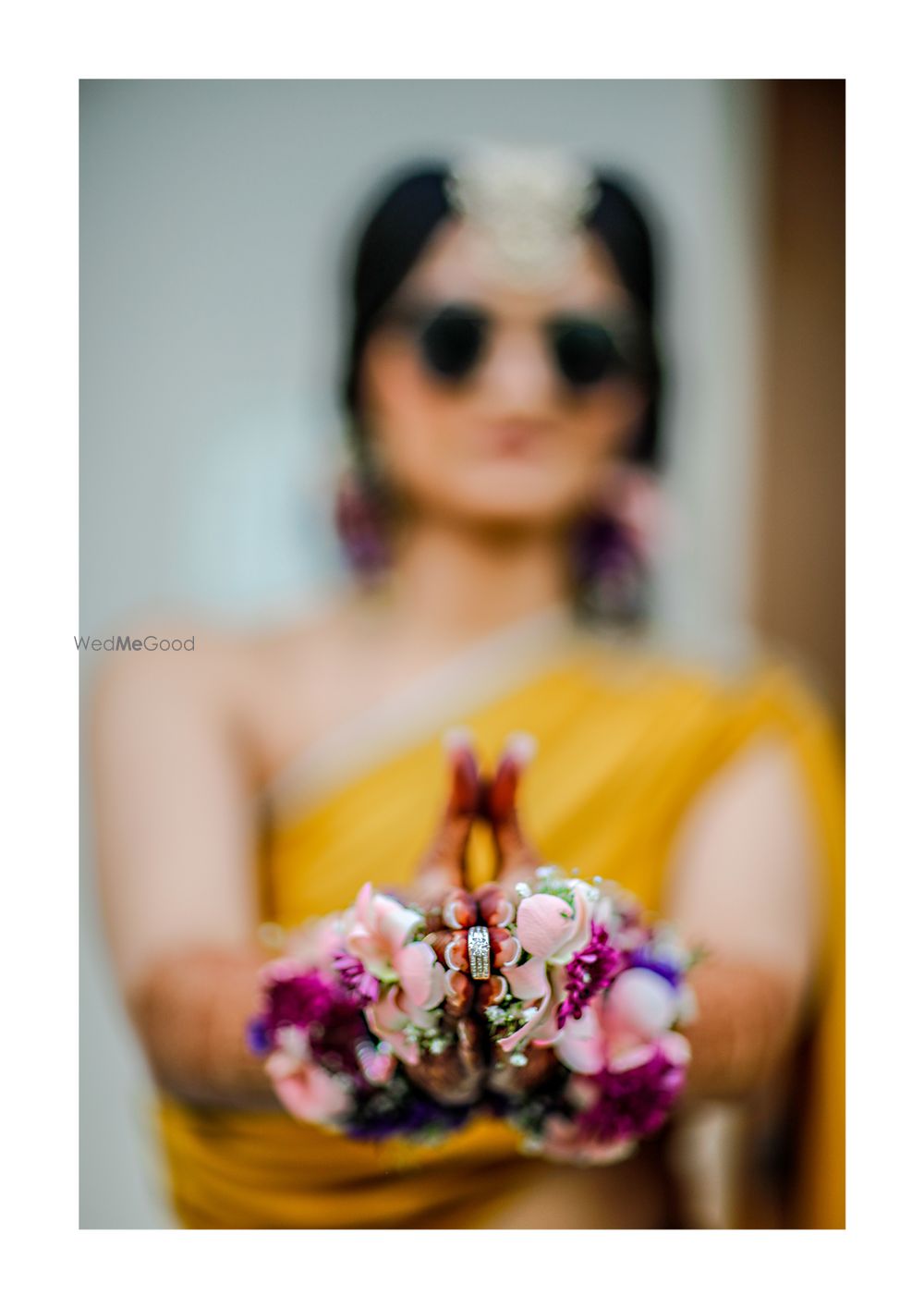 Photo of Bride holding engagement ring