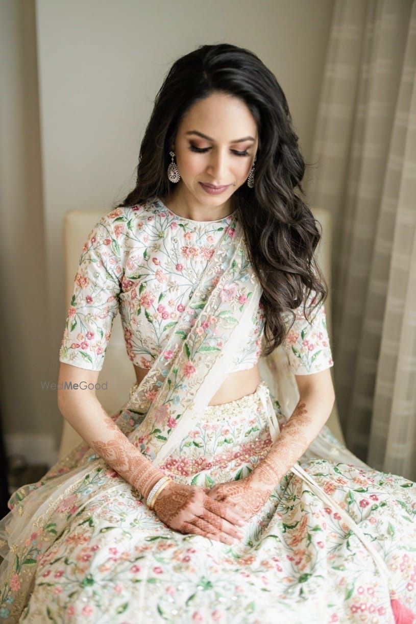 Photo of Bride dressed in an ivory lehenga with elegant thread work.