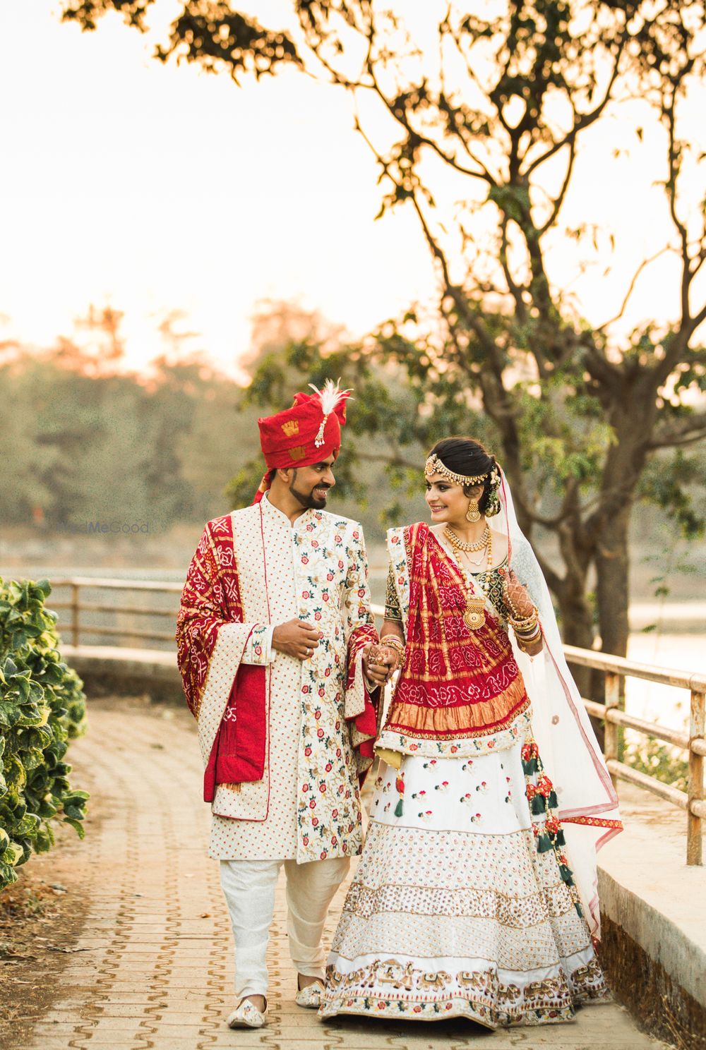 Photo of Twinning matching bride and groom in white and red