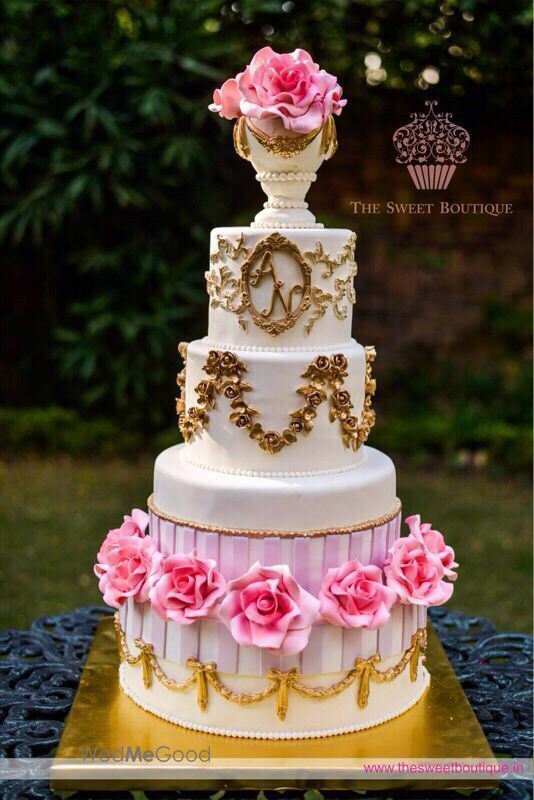 Photo of multi story white and gold wedding cake