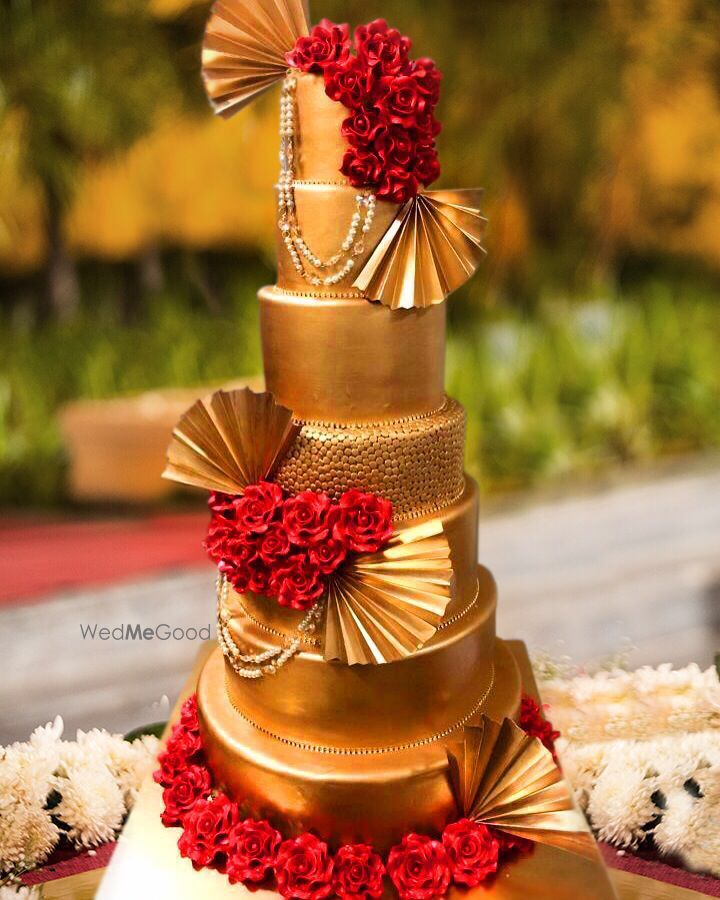 Photo of Glamorous gold and red wedding cake