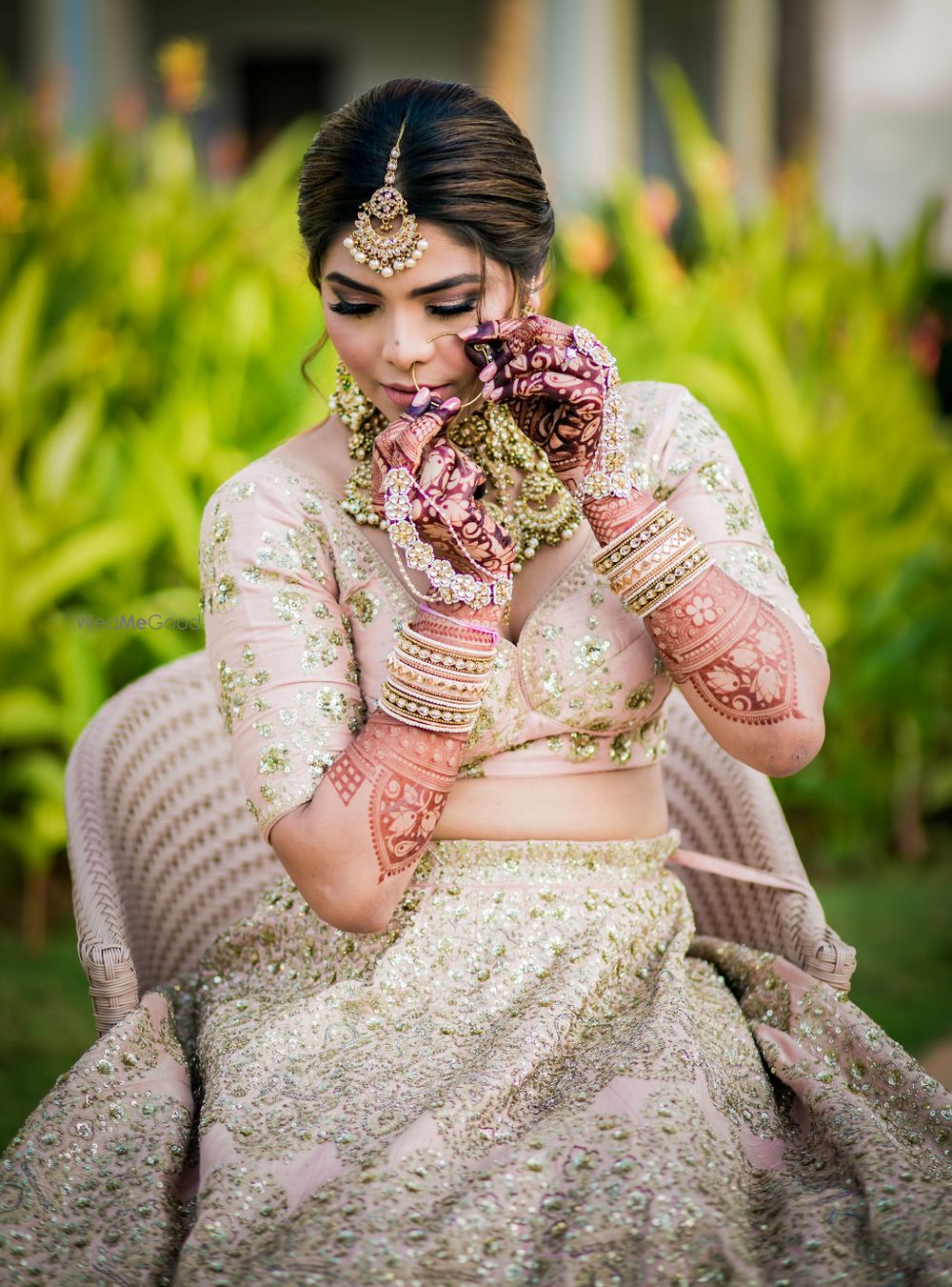 Photo of Wedding day bridal portrait in dull pink lehenga