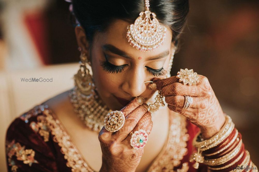 Photo of Bridal getting ready moment wearing her nath