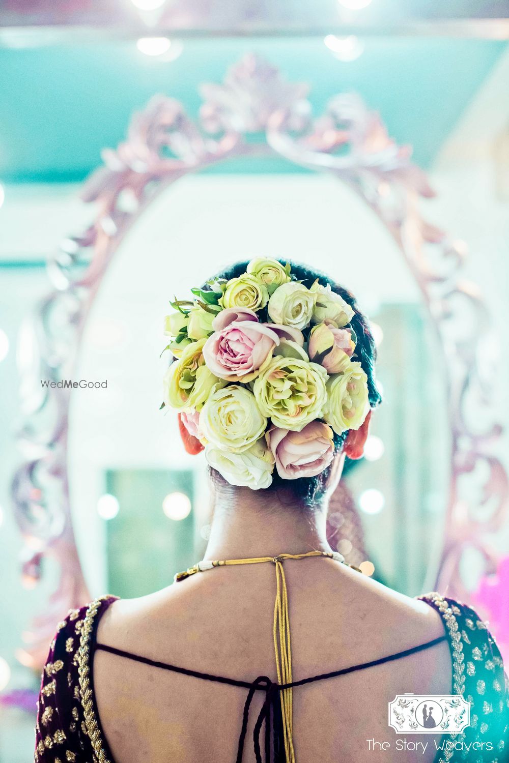 Photo of Unique bridal bun with big yellow and pink roses contrasting with dupatta