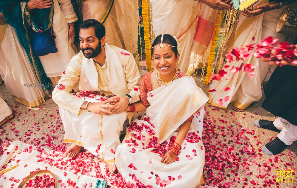 Photo of Happy Couple Shot with Rose Petals