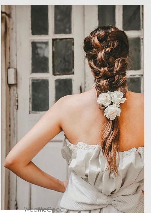 Photo of A Christian bride in a braid with roses