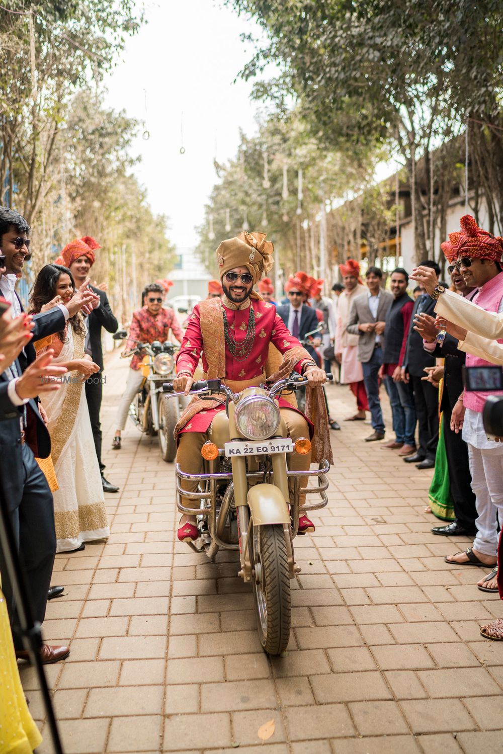 Photo of Groom entering his wedding on a bike