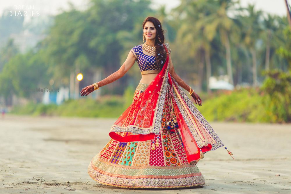 Photo of Twirling bride in multicolored lehenga