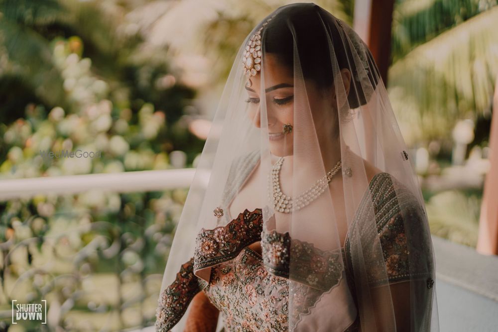 Photo of wedding day bride in dusty pink dupatta veil