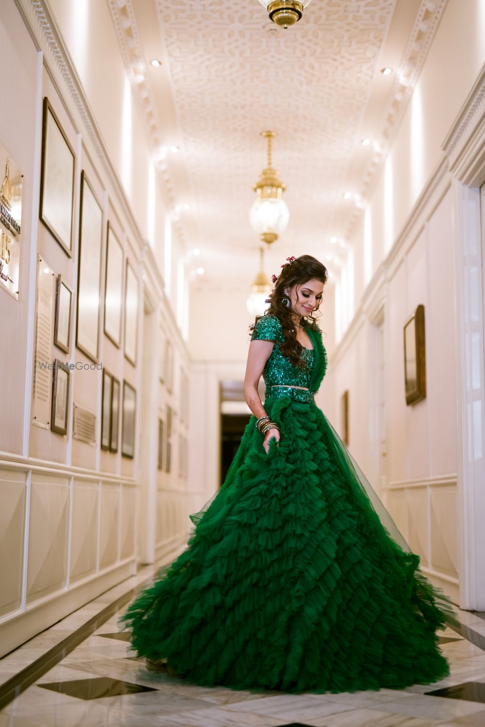 Photo of A bride in a ruffled green lehenga