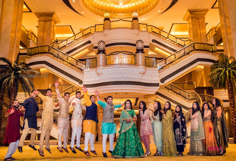 Photo of couple with bridesmaids and groomsmen on mehendi