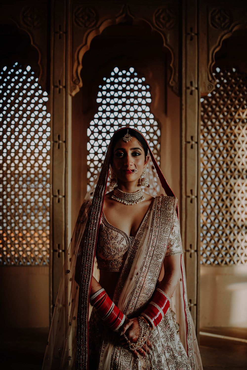 Photo of destination wedding bridal pose idea in ivory lehenga