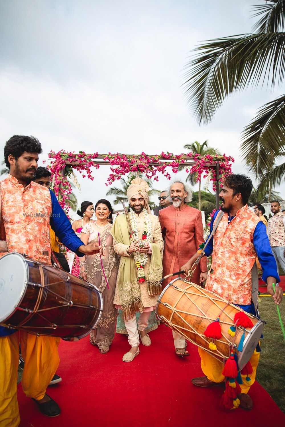 Photo of Groom entering with parents with dhols.