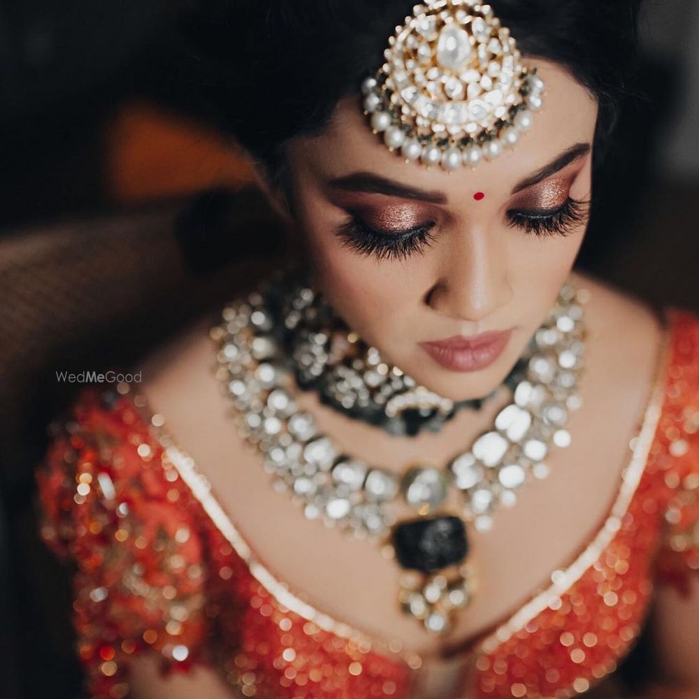 Photo of A wedding day bridal makeup look with shimmer rose gold eyes