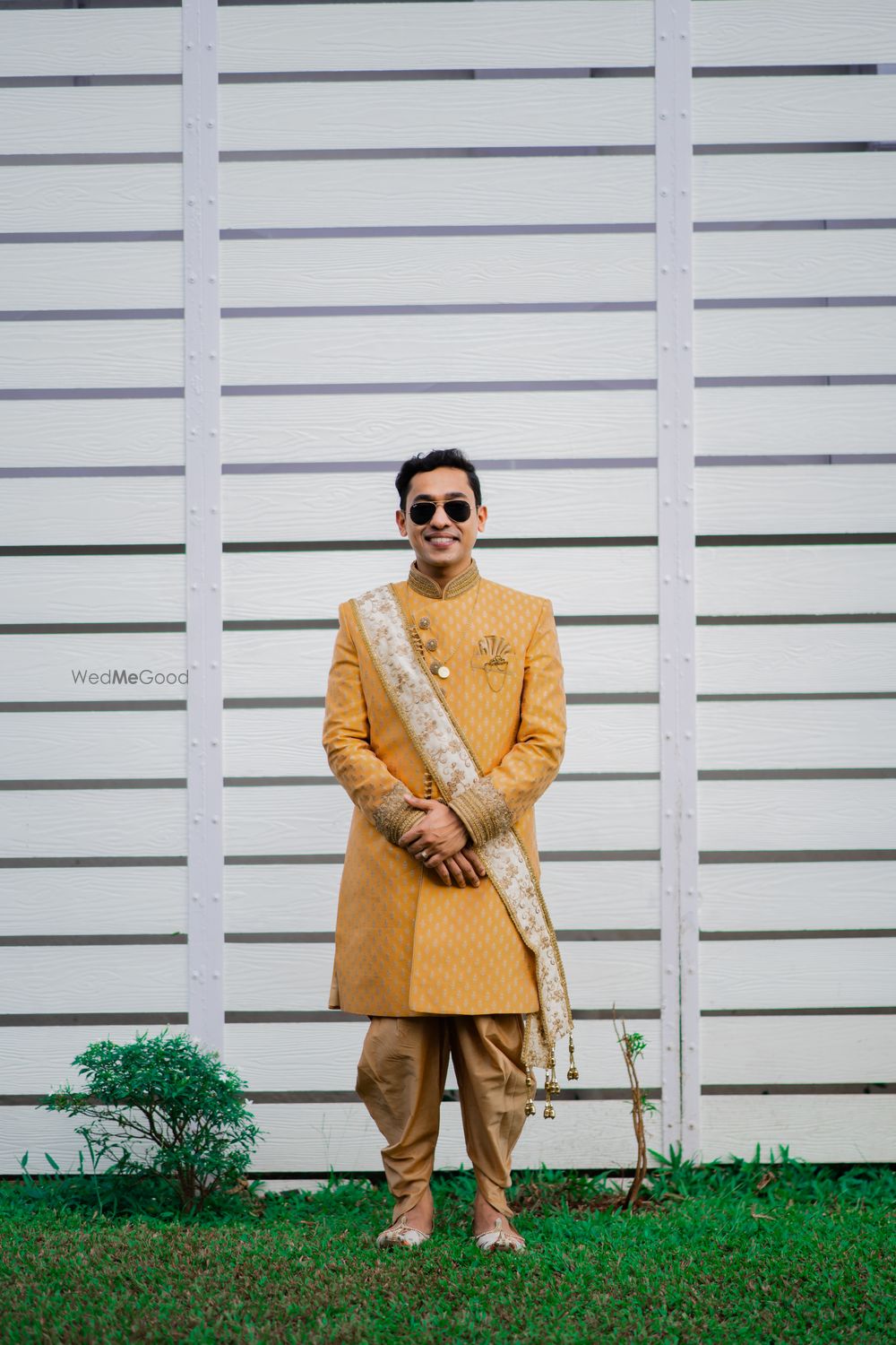 Photo of Groom dressed in a yellow bandhgala with a jodhpuri style pants.