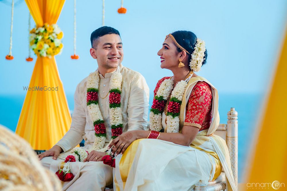 Photo of Candid shot of South Indian bride and groom looking at each other.